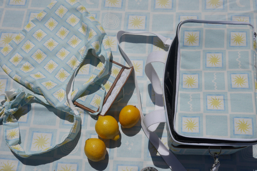 Blue ZAZZA Picnic collection: tote bag, cooler bag and picnic blanket styled with lemons 