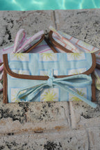 All ZAZZA sunglasses cases on a stone surface near a pool
