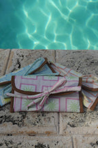 All ZAZZA sunglasses cases on a stone surface near a pool.