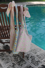ZAZZA Tote bags hanging on a chair by a poolside