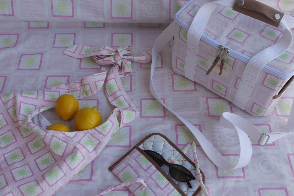 ZAZZA Pink Cooler Bag styled with picnic collection, a pair of sunglasses and lemons 