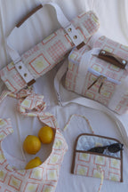 ZAZZA red picnic collection, styled on a white background with lemons & a pair of sunglasses